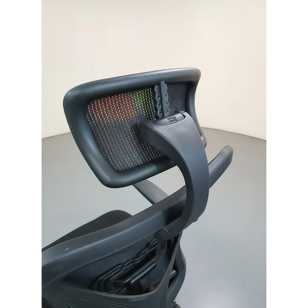 Neva Edge rear close-up of the mesh headrest, support bracket and backrest frame