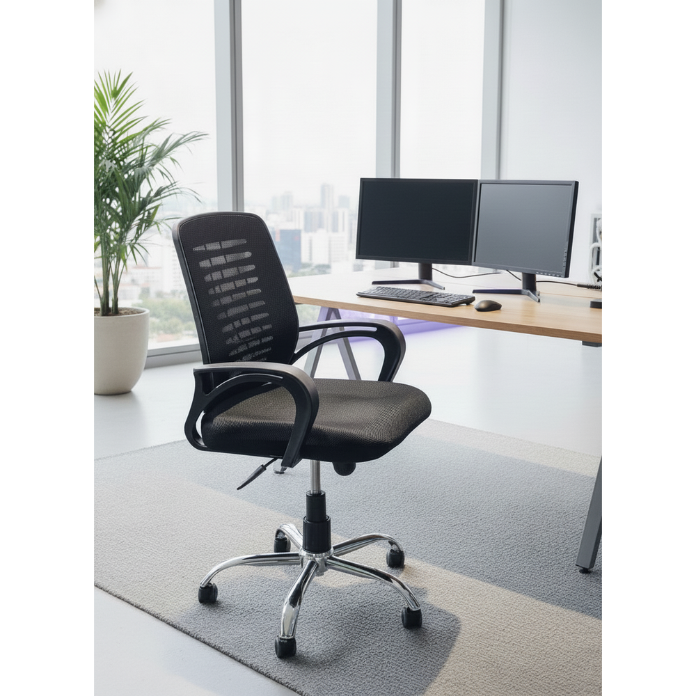 Neva Task black mesh chair beside a dual-monitor desk and large windows