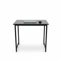 Black desk with a computer monitor and mouse on a white background