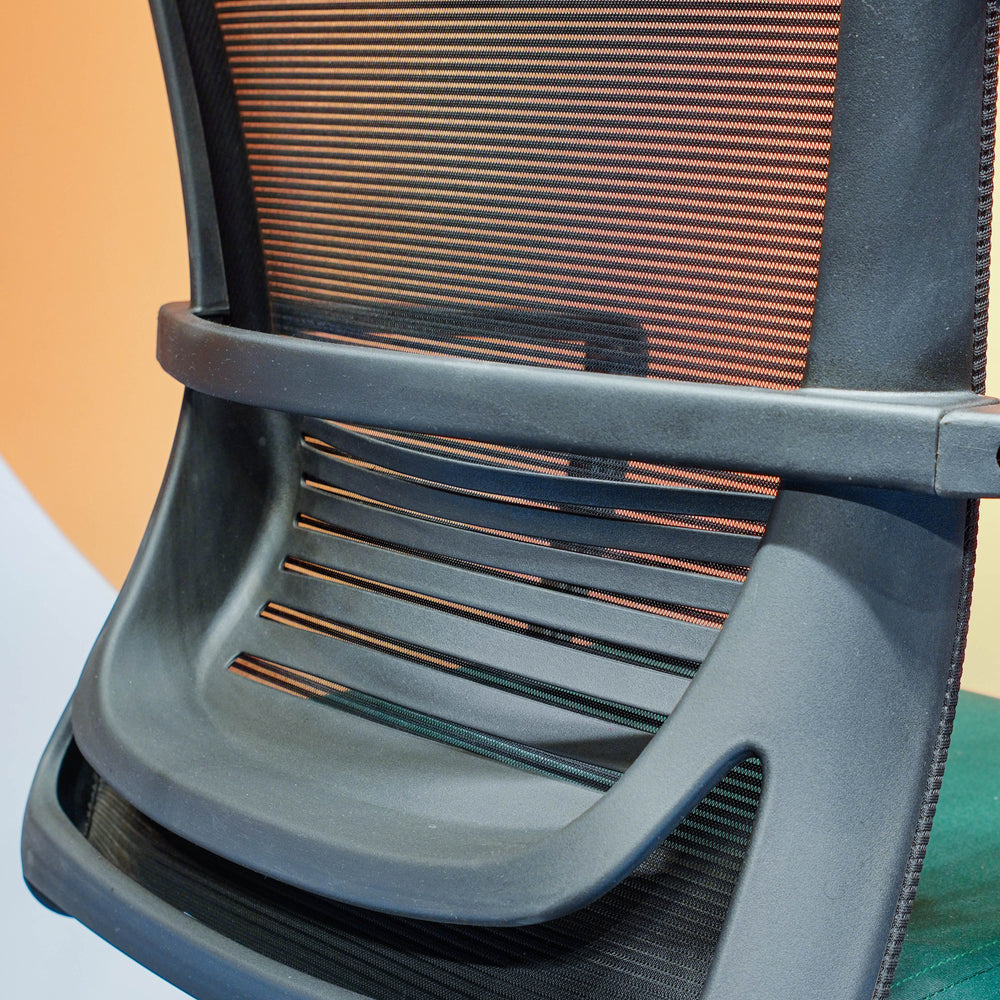Neva Furniture Vibe Chair black mesh back with orange undertones and ergonomic lumbar support.