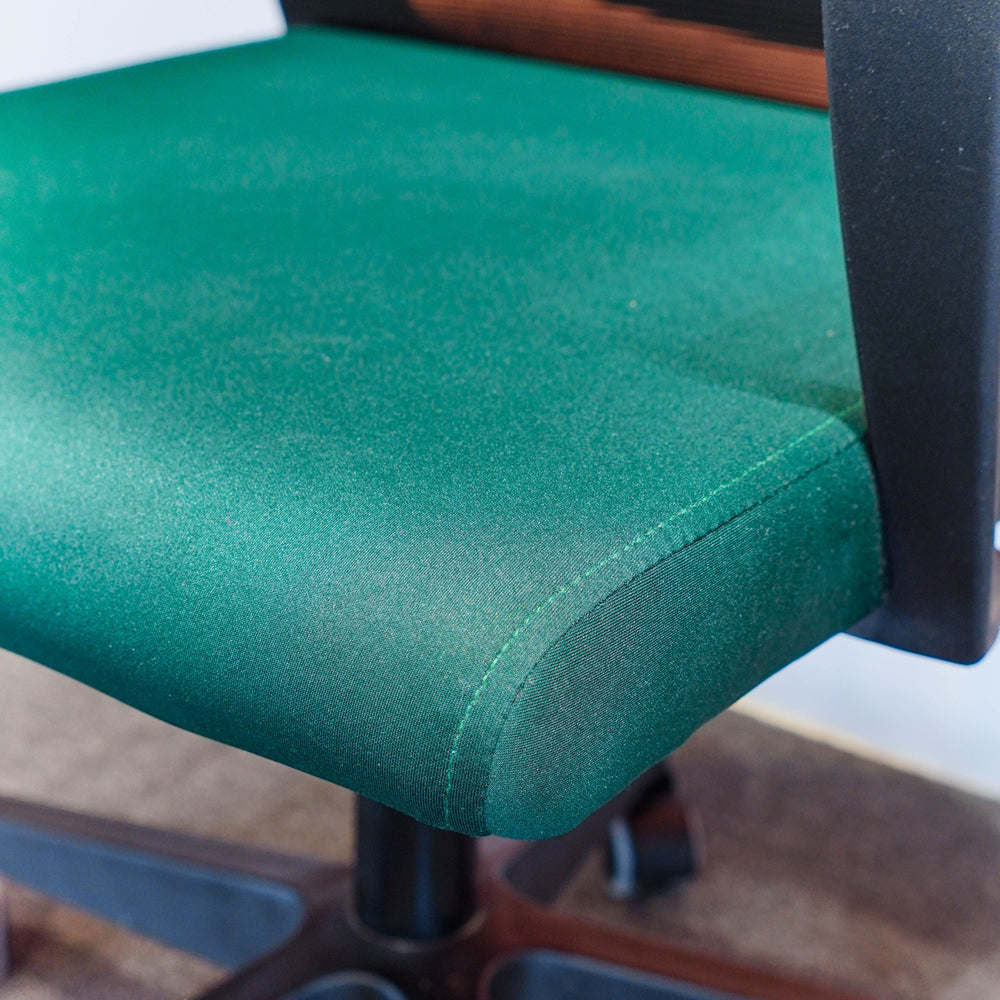 Neva Furniture Vibe Chair in emerald green fabric with cushioned seat and breathable mesh back. Ergonomic office chair with adjustable height and tilt lock.