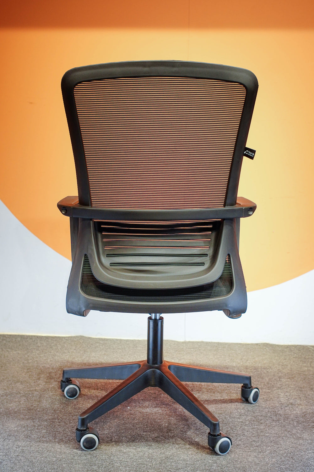 Neva Furniture Vibe Chair with black mesh back and cushioned seat, featuring adjustable height and tilt lock. Ideal for home office.