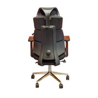 Neva Lynk black office chair rear view with central support spine, two visible side levers and chrome base