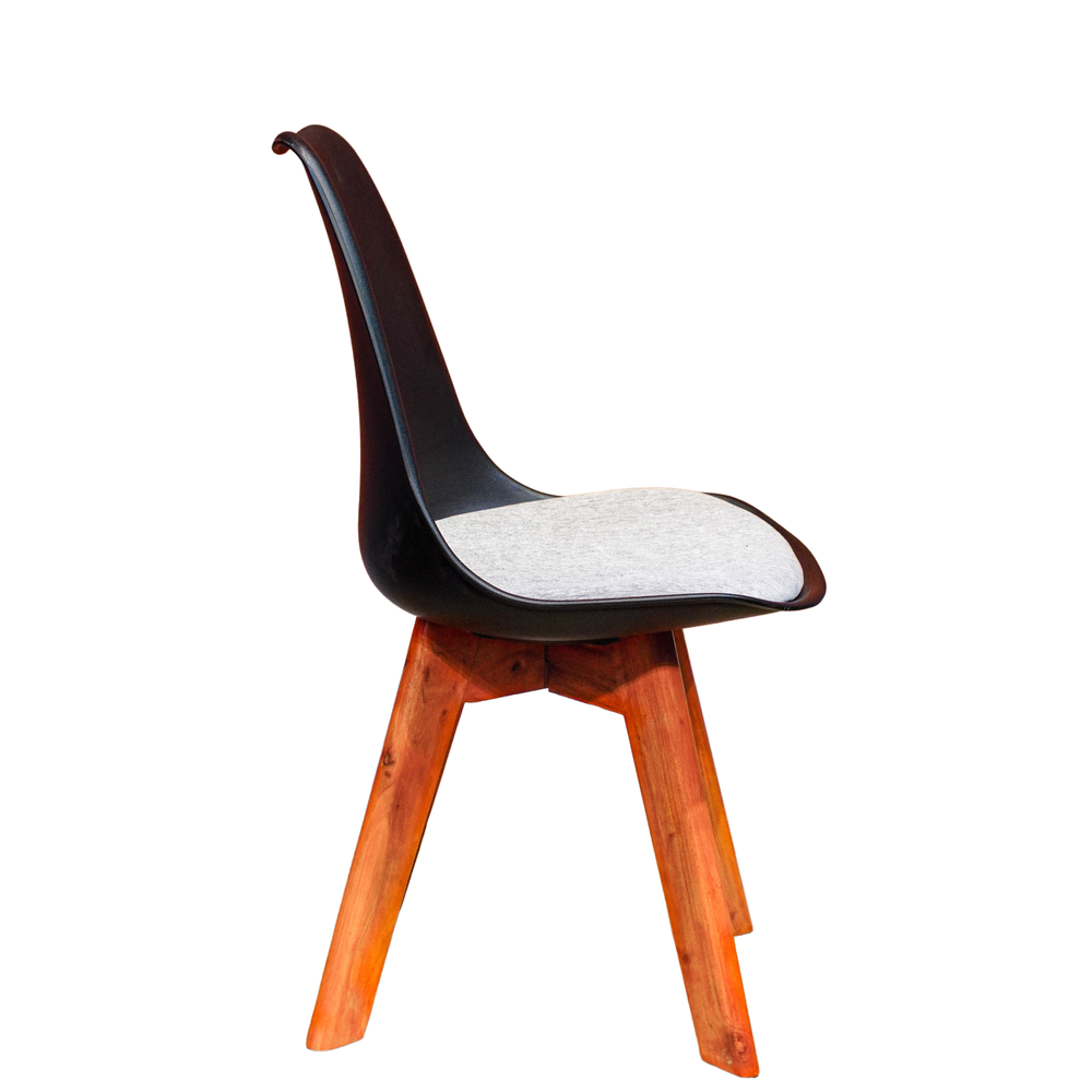 Neva Tulip Black shell chair, side view showing the curved back, raised seat rim and tapered wooden legs
