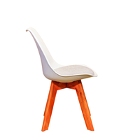 Neva Tulip White shell chair, side view of the curved plastic shell, fabric cushion and wooden legs